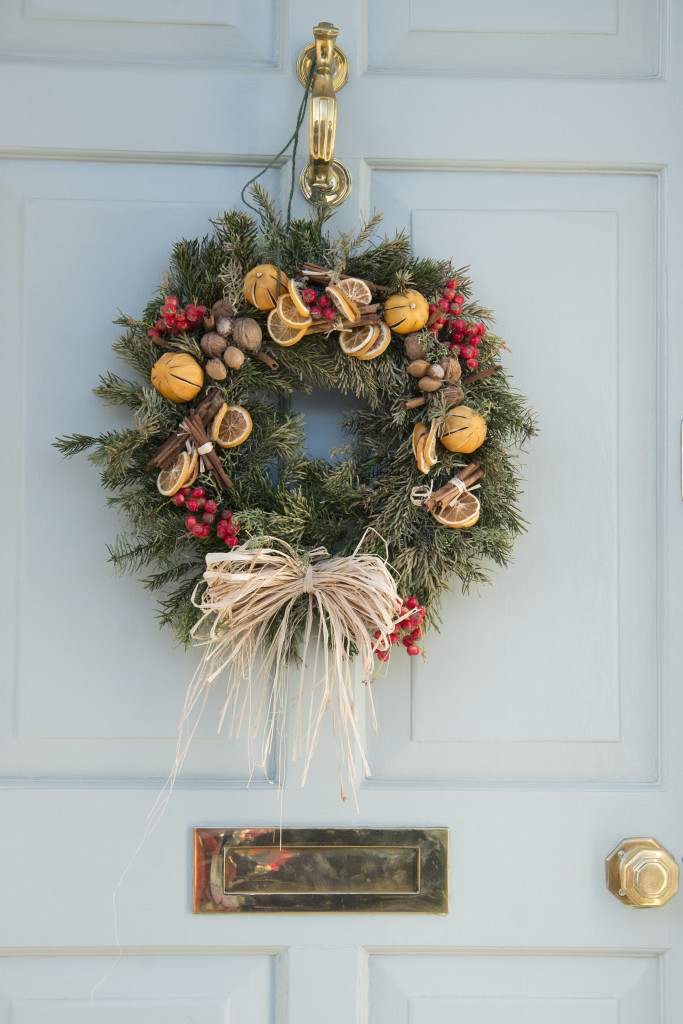 Pail blue doorway with brass fittings and a large xmas wreath
