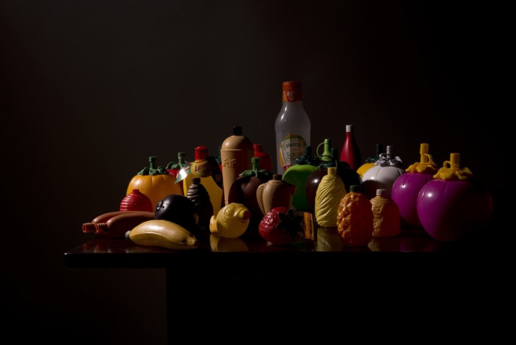 Still life of plastic containers with dark backdrop