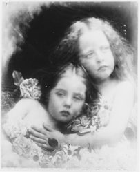 B&W photograph of two young girls looking angelic