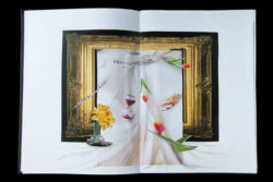 Artists sketchbook with a paper collage of a frame draped in cloth and objects